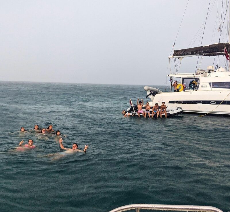 middle school students and catamaran in Caribbean on dive and sail summer program