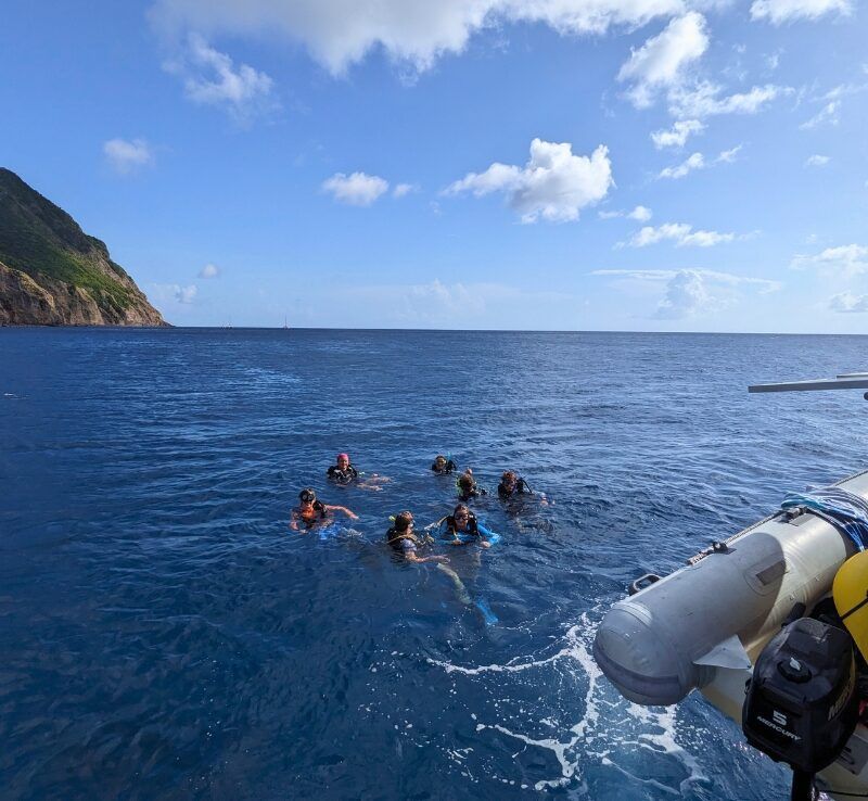 group of middle school students in water learning to scuba dive