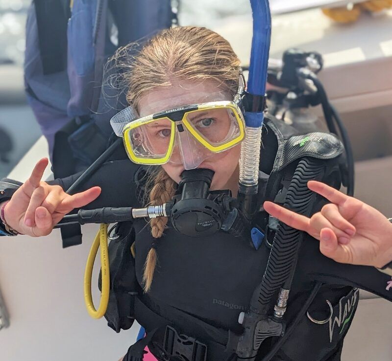 middle school girl in scuba gear on catamaran in the Caribbean