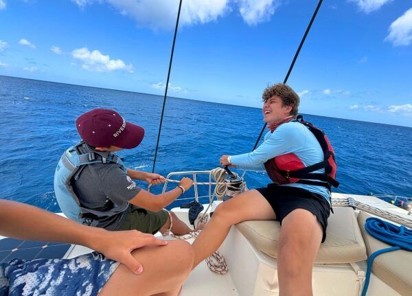 middle school students learning to sail on a catamaran in the Caribbean
