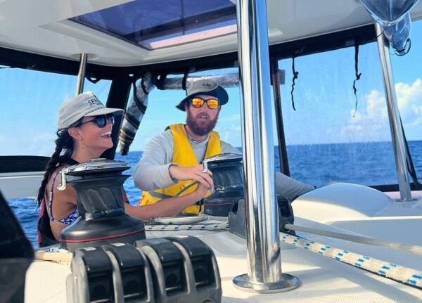 high school student learns to sail from sailing instructor on catamaran in the Caribbean