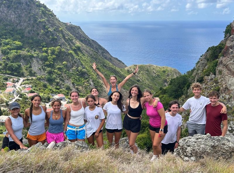 group of high school students pose on hike on Caribbean island