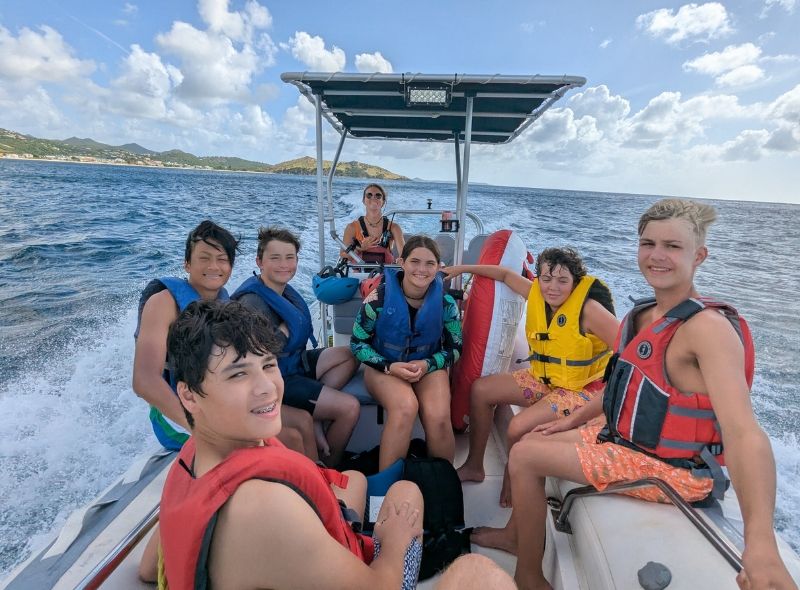 group of middle school students on boat in the Caribbean on summer scuba and sailing program