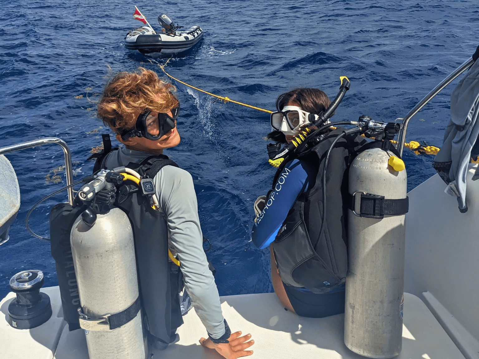 “teen scuba camp Caribbean students in dive gear on catamaran”
